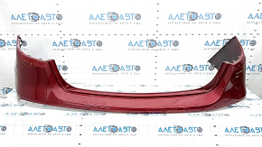 The bare rear bumper of a Buick Encore 17-22 without BSM, without reflector brackets, is dented, torn, has broken fasteners and scratches.