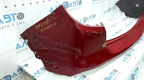 The bare rear bumper of a Buick Encore 17-22 without BSM, without reflector brackets, is dented, torn, has broken fasteners and scratches.