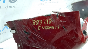 The bare rear bumper of a Buick Encore 17-22 without BSM, without reflector brackets, is dented, torn, has broken fasteners and scratches.