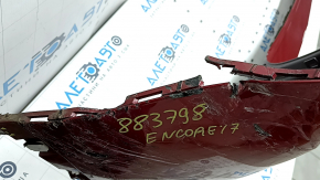 The bare rear bumper of a Buick Encore 17-22 without BSM, without reflector brackets, is dented, torn, has broken fasteners and scratches.