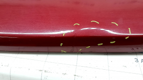 The bare rear bumper of a Buick Encore 17-22 without BSM, without reflector brackets, is dented, torn, has broken fasteners and scratches.