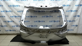 The tailgate is bare, dented, and has dents, for a 19-24 Ford Edge UX silver.