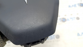 The Tesla Model Y 20-25 driver's steering wheel airbag is black and scratched.