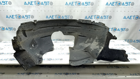 The front right fender liner of a 17-22 Buick Encore is dented and has tears.
