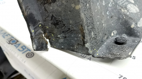 The front right fender liner of a 17-22 Buick Encore is dented and has tears.