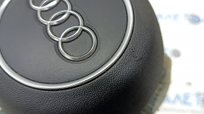 Black steering wheel airbag for the driver's side of the Audi A4 B9 17-25, with chrome accents.