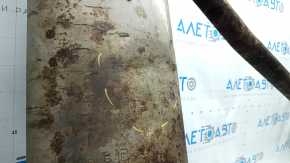 The rear muffler with the barrel of a 19-21 LUV Buick Encore is rusty and the barrel is dented.