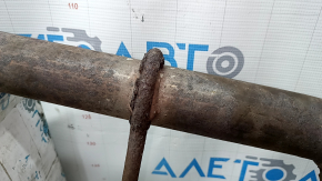 The rear muffler with the barrel of a 19-21 LUV Buick Encore is rusty and the barrel is dented.