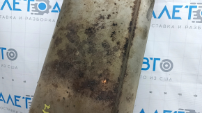 The rear muffler with the barrel of a 19-21 LUV Buick Encore is rusty and the barrel is dented.