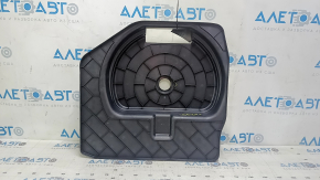 The trunk tray for the spare tire of an Audi A4 B8 08-16 sedan has scratches, a dent, and a tear.