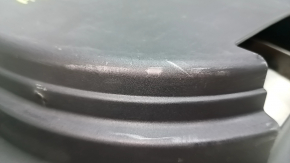 The trunk tray for the spare tire of an Audi A4 B8 08-16 sedan has scratches, a dent, and a tear.