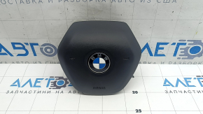 The airbag in the driver's steering wheel of the BMW 3 G20 19-24 is black and scratched.
