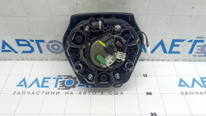 The airbag in the driver's steering wheel of the BMW 3 G20 19-24 is black and scratched.