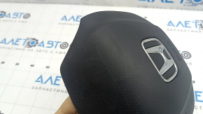 The Honda CRV 20-22 driver's steering wheel airbag is black and scratched.