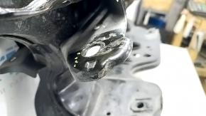 The rear subframe of an Infiniti QX50 19-25 FWD has a dented camber bolt.