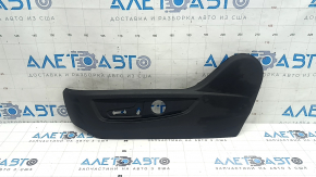 Infiniti QX50 19-25 driver's seat control cover is black, with cracks in the fasteners.