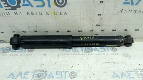 The rear left shock absorber of a Nissan Rogue 14-17 AWD is dented.