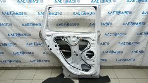 The door is bare, rear left, Honda CRV 17-22, white NH-883P, dented, with bumps and scratches.
