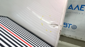 The front left door of a Honda CRV 17-22, white, NH-883P, is dented, has dents, and scratches.