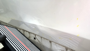 The front left door of a Honda CRV 17-22, white, NH-883P, is dented, has dents, and scratches.
