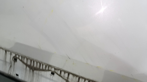 The front left door of a Honda CRV 17-22, white, NH-883P, is dented, has dents, and scratches.