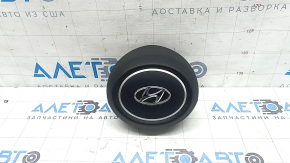 The steering wheel airbag for the driver's side of a Hyundai Tucson 2022-2024 is black and scratched.