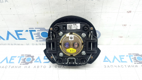The steering wheel airbag for the driver's side of a Hyundai Tucson 2022-2024 is black and scratched.
