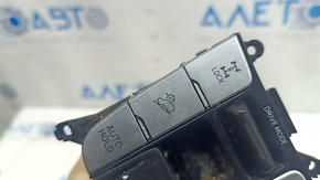 The Hyundai Tucson 22-24 center console button block has peeling coating and scratches.