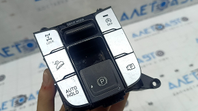 The Hyundai Tucson 22-24 center console button block has peeling coating and scratches.