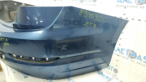 The rear bumper of a 19-21 VW Jetta is bare and blue, with paint peeling off.
