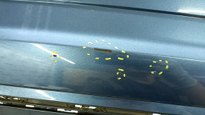 The rear bumper of a 19-21 VW Jetta is bare and blue, with paint peeling off.