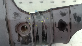 The lower control arm lining under the rear left spring is dented for an Audi A6 C8 19-25.