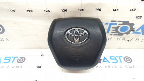 The Toyota Venza 21-24 driver's steering wheel airbag is black and scratched.