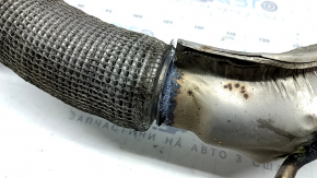 The exhaust pipe with catalytic converters for a VW Jetta 19-21 1.4T is rusty and the mesh is torn.