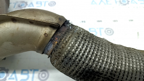 The exhaust pipe with catalytic converters for a VW Jetta 19-21 1.4T is rusty and the mesh is torn.