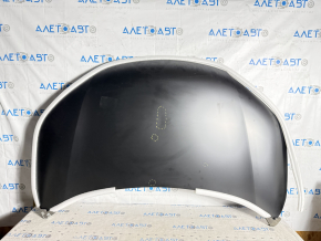 The hood of a Honda CRV 12-16 is bare, dented, and dented.