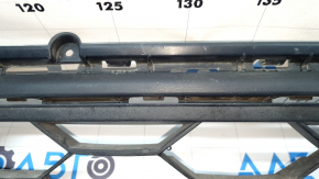 The lower grille of the front bumper, central, VW Tiguan 18-21 is dented.