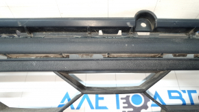 The lower grille of the front bumper, central, VW Tiguan 18-21 is dented.