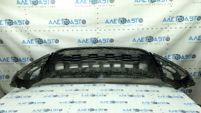 The front bumper lip of the VW Tiguan 18-21 is worn and dented.