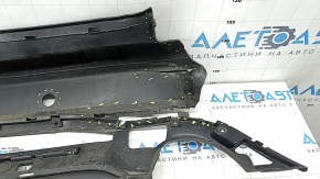 Bare rear bumper for Ford Escape MK4 20-26 with parking sensors and no towbar. Structure, scratches, and detached parking sensor ring.