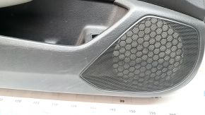 The front left door panel of a 1922 Honda Accord is black with a light gray leather insert. The armrest is light gray leather, and the wood-like molding has scratches and wear.