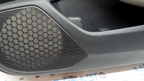 The front right door panel of a 1922 Honda Accord is black with a light gray leather insert. The armrest is light gray leather, and the wood-like molding has scratches and wear.