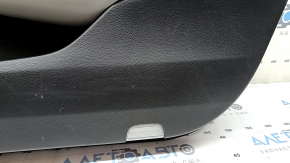 The front right door panel of a 1922 Honda Accord is black with a light gray leather insert. The armrest is light gray leather, and the wood-like molding has scratches and wear.
