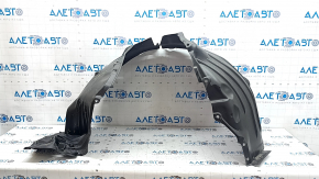 The front left fender liner of a Mazda CX-90 24-26 is dented, torn, and punctured.