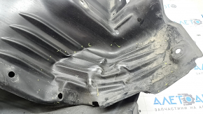 The front right fender liner of a Mazda CX-90 24-26 is dented.