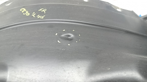 The front right fender liner of a Mazda CX-90 24-26 is dented.