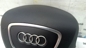 The steering wheel airbag for the driver's side of the Audi Q5 8R 13-17 is black and scratched.