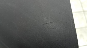 The front bumper lip of a Porsche Macan 15-18 is cracked, dented, has scratches, and has cracks in the fasteners. After repair