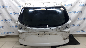 The trunk door is bare with glass for a Mazda CX-9 16-18, electric, white 25D, dented.