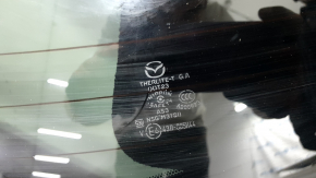 The trunk door is bare with glass for a Mazda CX-9 16-18, electric, white 25D, dented.